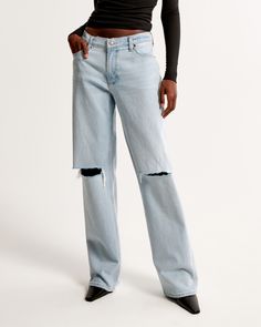 Our classic low rise baggy jeans in a light wash, with knee blowout details and a clean hem. This fit features a 8.5” low rise, is slightly relaxed at waist and hips, and eases at the thigh into a baggy, full-length leg shape. We recommend buying your true size for a baggier fit. Size down for a closer fit. This jean is made from our vintage stretch fabric which features both an authentic vintage look and contains slight built-in stretch for additional comfort. Light Wash Cutoff Jeans For Streetwear, Relaxed Fit Light Wash Ripped Flare Jeans, Everyday Ripped Relaxed Fit Flare Jeans, Everyday Ripped Flare Jeans With Relaxed Fit, Everyday Relaxed Fit Ripped Flare Jeans, 2000s Fashion Aesthetic, Low Rise Baggy Jeans, Baggy Jean, Sequin Jumpsuit