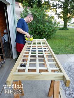 a man is sanding up the wood for a table top bench that's being built