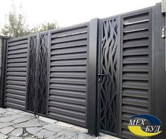 a black gate with decorative designs on it