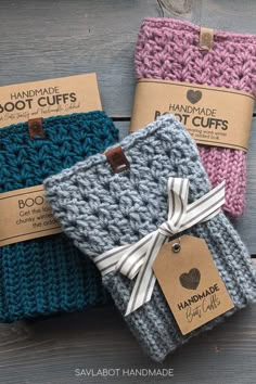 three handmade knitted gift bags with tags on them