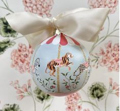 a blue ornament with a white bow on it's neck and an image of a tiger