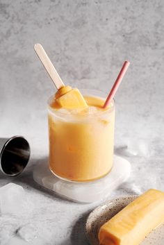 mango melon sou cocktail in a glass with two straws on the side