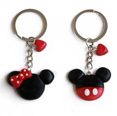 two mickey mouse keychains with red hearts on them and one has a minnie mouse head