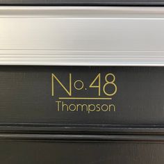 the name and number on the door of a train car that is black with gold lettering