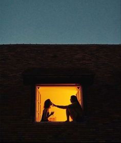 two women are standing on the roof of a building and one is holding her hand out to another woman