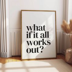 a white framed poster with the words what if it all works out? next to a plant