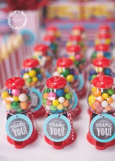 candy dispensers sitting on top of a table with thank you stickers