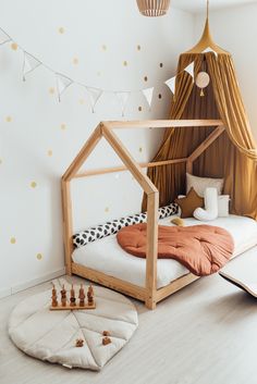 a child's bedroom with a teepee tent, bed and chess pieces on the floor