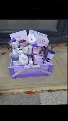 a purple box filled with lots of items on top of a cement floor next to a door