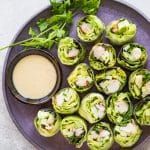 a plate with rolls and dipping sauce on it