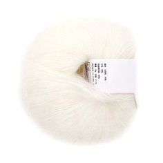 a skein of white yarn with a tag on the end, in front of a white background