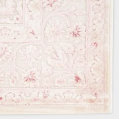 a pink and white rug with an intricate design