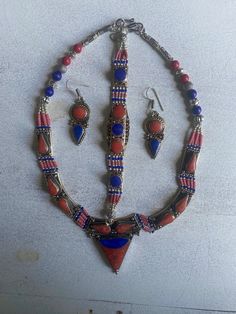 (MARKED DOWN FROM $125)  This is a gorgeous jewelry set: Necklace, Bracelet, Dangle Hook Earrings.  This set is truly one of a kind (vintage) with multi colors in the pieces (as seen in photo). NECKLACE Length: 18" inches Main Stone: Lapis Lazuli Main Shell: Red Coral; Spinny Oyster Metal: Silver Plate; Tibetan Silver Main Colors: Red, Blue, Orange, Silver BRACELET Length: 7.5" inches  Main Stone: Blue Turquoise Main Shell: Red Coral Metal: Silver Plate; Tibetan Silver Main Colors: Blue, Red, Si Tibetan Jewelry The Little Tibet, Tibetan Earrings, Tibetan Necklace, Tibetan Bracelet, Tibetan Jewelry, Wedding Jewelry Sets, Gorgeous Jewelry, Red Coral, Hook Earrings