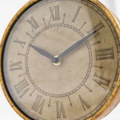 an old clock with roman numerals on it's face is shown against a white background