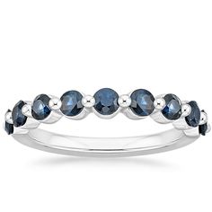 a white gold ring with blue sapphire stones