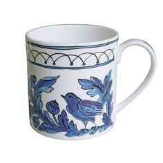 a blue and white coffee cup with birds on it