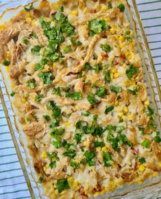 a casserole dish with chicken, corn and cilantro garnish