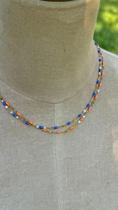 Florida Gators game day necklace designed by Bromley Squared. This dainty orange and blue enamel beaded chains are double layers and will accessorizes any game day outfit. The pops of orange and blue enamel measure a mere 1.5 mm.  Go Gators! Extension chain 2" Everyday Colorful Beads Orange Jewelry, Orange Double Strand Beaded Necklace As Gift, Orange Double Strand Beaded Necklace For Gift, Handmade Orange Double Strand Necklace, Orange Multi-strand Colorful Beads Jewelry, Orange Multi-strand Necklaces For Gifts, Orange Multi-strand Jewelry Gift, Multi-strand Orange Necklaces For Gifts, Orange Multi-strand Jewelry For Gifts