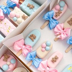 two boxes filled with decorated cookies in the shape of teddy bears and bow ties on top of each other