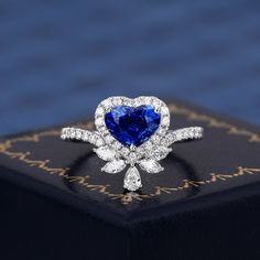 a blue and white heart shaped diamond ring