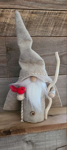 an old fashioned gnome with a red hat and white beard is sitting on a shelf