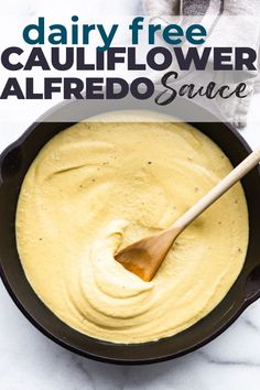 dairy free cauliflower alfredo sauce in a skillet with a wooden spoon