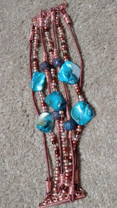 On trend boho leather multistrand bracelet. Stunning turquoise shell, czech glass and blue beads with copper wire work on genuine brown round leather cord. Matching copper closure that slides in for easy put on-take off. Can also use a magnetic option- it's up to you! I make these to order so that they can fit you perfectly. Write to me with your zip/postal code so that I can give you a more accurate shipping estimate. Multistrand Bracelet, Boho Turquoise, Postal Code, Multi Strand Bracelet, Boho Leather, Round Leather, Pearl Shell, Wire Work, Blue Beads