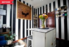 a kitchen with black and white striped walls