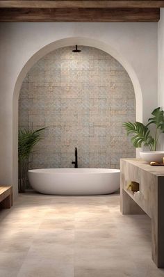 a bathroom with a tub, sink and potted plant