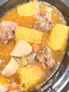 corn on the cob and beef stew in a slow cooker