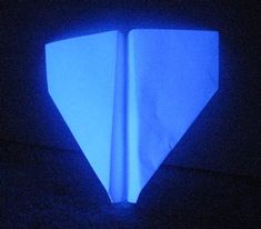 an origami piece in the dark with blue light coming from it's center