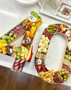 a number made out of fruits and vegetables sitting on top of a white countertop