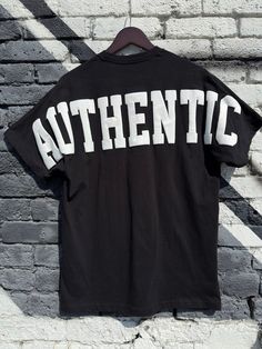 Black "Authentic" T-Shirt Oversized Hip Hop Tops With Letter Print, Hip Hop Oversized Slogan Tops, Oversized Hip Hop Tops With Slogans, Oversized Cotton Grunge T-shirt, Urban Streetwear T-shirt With Back Print, Cotton T-shirt With Front And Back Print For Streetwear, Alternative Oversized Streetwear Top, Oversized Hip Hop T-shirt With Letter Print, Oversized Letter Print T-shirt For Streetwear