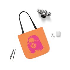 an orange and pink tote bag with a woman's face on it