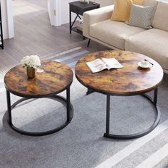 two coffee tables sitting on top of a rug in a living room