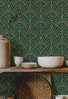 a shelf with plates and bowls on it in front of a wallpapered background