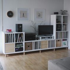 a living room filled with lots of furniture and bookshelves on top of each other