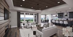 a living room filled with furniture next to a kitchen and an open concept floor plan