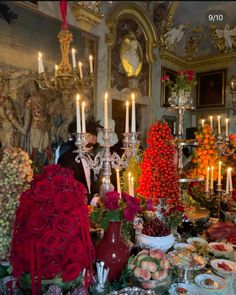 a table filled with lots of food and candles