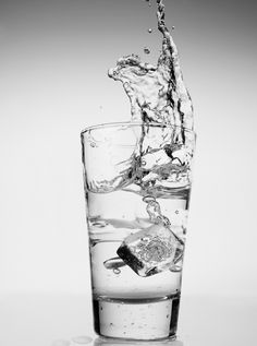 a glass filled with water and ice cubes