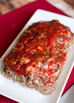 the meatloaf is covered with sauce and ready to be eaten on the table