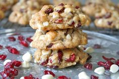 three cookies stacked on top of each other with cranberries and white chocolate chips