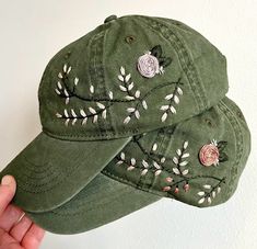 Hand embroidered green hat with floral design spread across left or right side of hat. Adjustable strap to fit all sizes with ponytail opening in back. Hand wash to preserve quality. Green Brimmed Baseball Cap, Green Adjustable Brimmed Baseball Cap, Adjustable Green Hat With Embroidered Logo, Embroidered Short Brim Baseball Cap, Adjustable Embroidered Green Hats, Green Embroidered Adjustable Hat, Adjustable Green Embroidered Hat, Green Hats With Embroidered Logo, One Size, Green Hats With Embroidered Logo