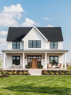 a large white house sitting on top of a lush green field