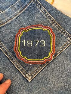 someone is showing off their jeans with the year 1971 on it and an embroidered badge