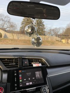 the dashboard of a car with disco balls hanging from it's ceiling