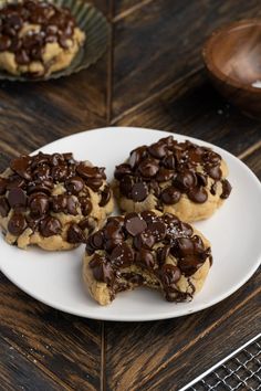 three chocolate chip cookies on a white plate