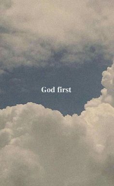 the words god first are written in white on a cloudy blue sky above some clouds