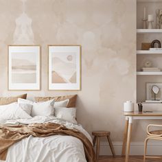 a bedroom with two framed pictures on the wall