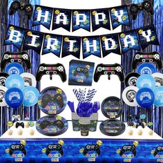 a birthday party set up with video game controllers and balloons, streamers and decorations